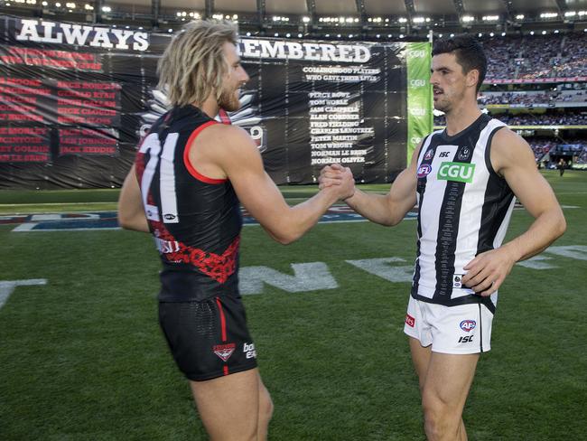 AFL Round 6. 24/04/2019. Richmond v Melbourne at the MCG.  Skippers Dyson Heppell  and Scott Pendlebury  meet infant of the banner pre game    . Pic: Michael Klein.