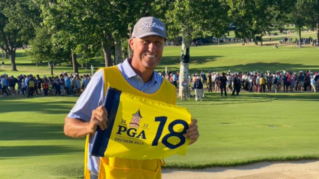 John Bones Mackay with 18th green flag