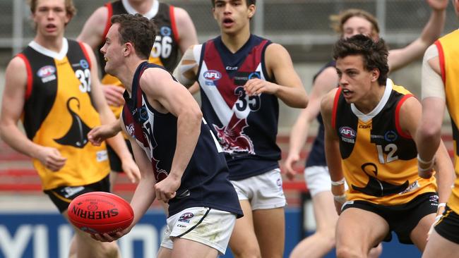 Jack Mahony handballs under pressure for Sandringham Dragons.