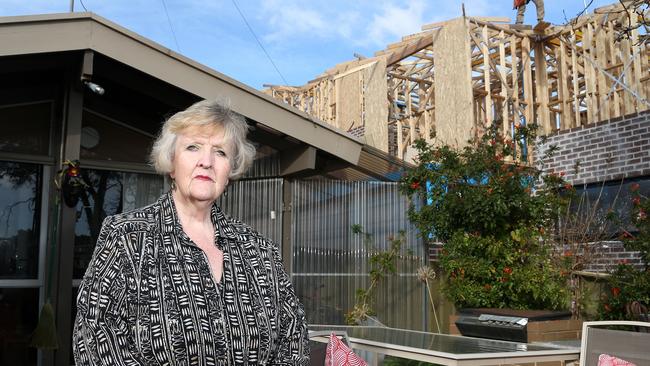 There are three townhouses under construction next to Mrs Ross’ home. Picture: Hamish Blair.