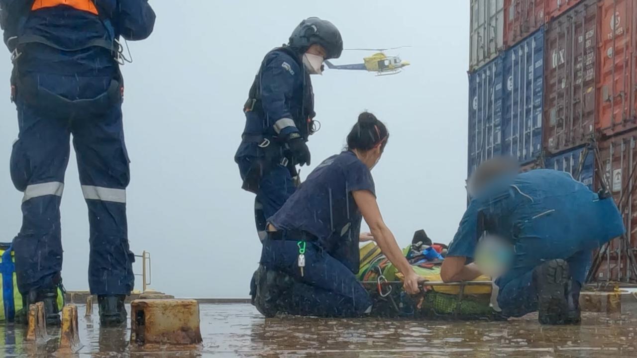 Paramedics and the RACQ LifeFlight crew working to treat the man during the wild weather off the coast of Mooloolaba. Picture: RACQ LifeFlight Rescue