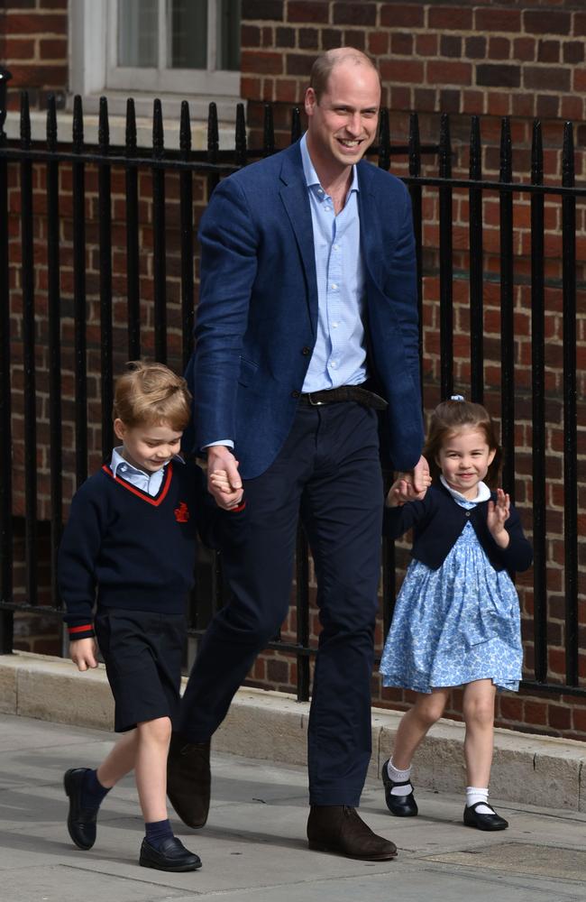 Princess Charlotte, with big brother Prince George and father Prince William, charmed the world with her cute wave to the crowds outside the hospital. Picture: Phil Loftus/Capital Pictures / MEGA