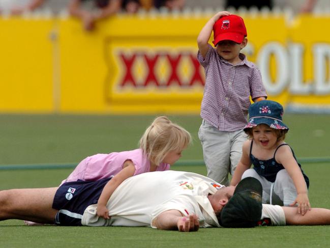 Matthew Hayden in 2004 gets bowled over by his daughter Grace (in pink) and the kids of teammates.