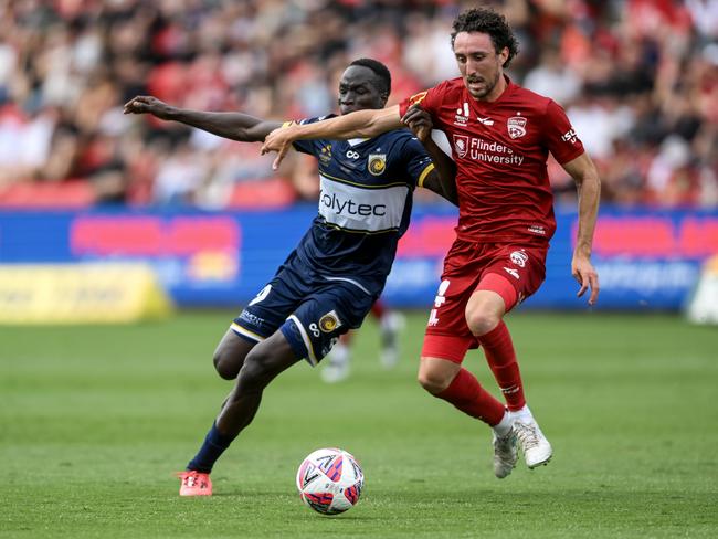 Central Coast’s Alou Kuol competes with Adelaide United’s Jay Barnett for the ball. Picture: Getty Images