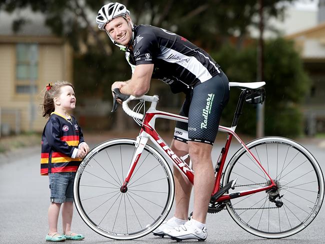 Adelaide Crows player Ben Rutten with Abby Harper from Camp Quality. 