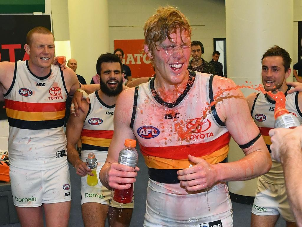 MELBOURNE, AUSTRALIA - AUGUST 25:  Elliott Himmelberg of the Crows is sprayed with drinks after the Crows won the round 23 AFL match between the Carlton Blues and the Adelaide Crows at Etihad Stadium on August 25, 2018 in Melbourne, Australia.  (Photo by Quinn Rooney/Getty Images)