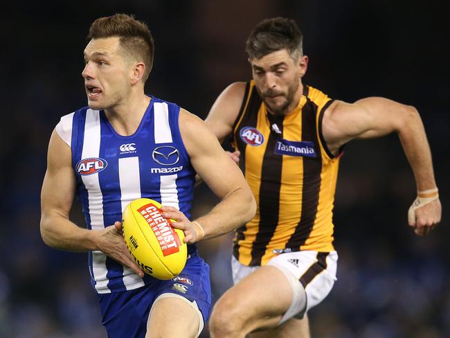 Shaun Higgins runs away from Hawthorn’s Ricky Henderson. Picture: Michael Klein