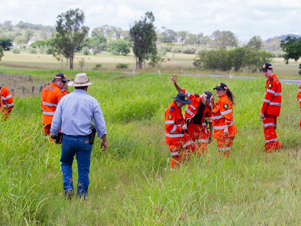 SES investigate the road and paddocks near the scene of the Biggenden fire, which is now being treated as a murder investigation.