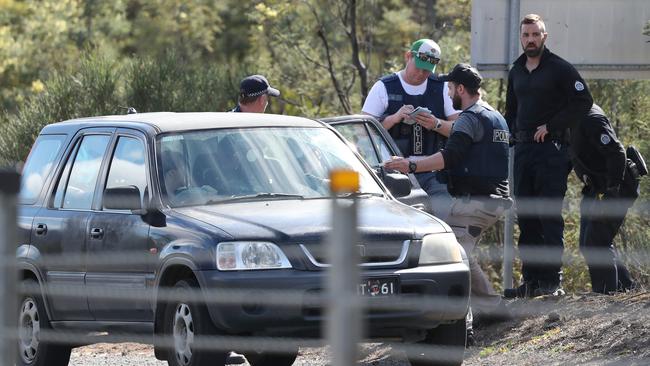 Tasmania Police members checking cars on the East Derwent Highway near the Risdon Prison. Picture: NIKKI DAVIS-JONES