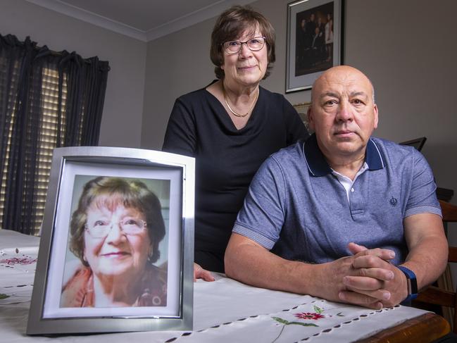 Sam Agnello and his sister, Dora Di Lorenzo, with a photo of their mum, Carmela, who died of coronavirus at the age of 92. Picture: Wayne Taylor