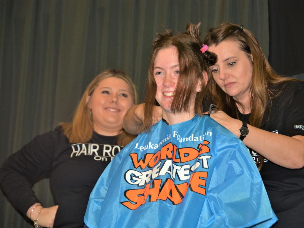 At the St Joseph's College 2023 World's Greatest Shave event is student Georgie Hansen getting her hair cut by hairdressers (from left) Georgie Harwood and Jillian Grundy. Picture: Rhylea Millar