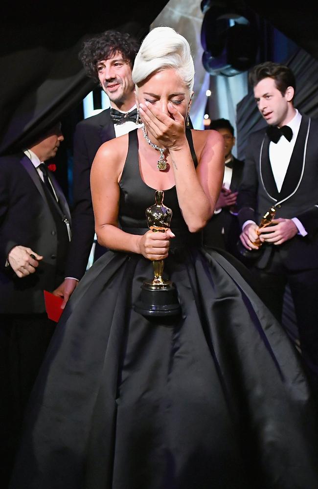 Overcome with emotion, Shallow singer Lady Gaga poses with her Oscar for Best Original Song. Picture: Getty Images 