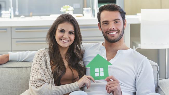 A young couple who have bought their first home and have a mortgage.