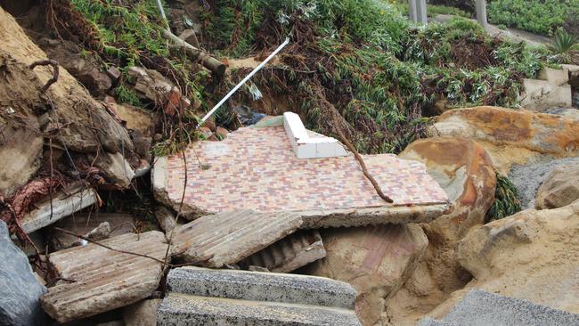 Two homes have partially collapsed during high tides and rough seas at Wamberal Beach.