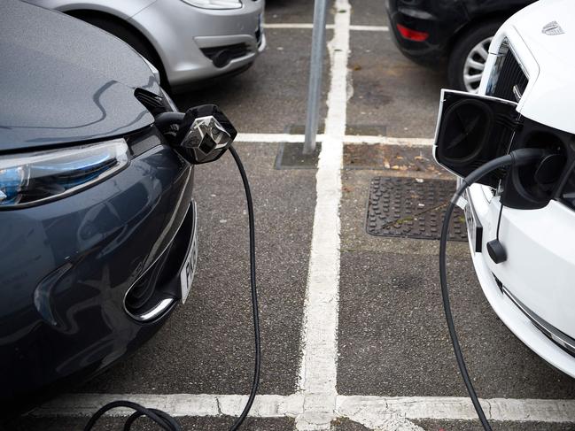 Electric vehicles (EV) charge at a charging station on east London on November 18, 2020. - Britain will ban petrol and diesel vehicle sales from 2030 as part of a 10-point plan for a "green industrial revolution" to be unveiled Wednesday by Prime Minister Boris Johnson. (Photo by DANIEL LEAL-OLIVAS / AFP)