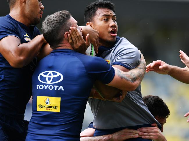 NRL; North Queensland Cowboys training at Queensland Country Bank Stadium. Peter Hola pushes through the defence of Ben Hampton and Connelly Lemuelu. Picture: Alix Sweeney