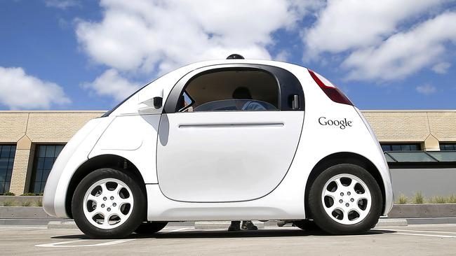 In this May 13, 2015 photo, Google's new self-driving prototype car is presented during a demonstration at the Google campus in Mountain View, Calif. The car, which needs no gas pedal or steering wheel, will make its debut on public roads this summer. (AP Photo/Tony Avelar)