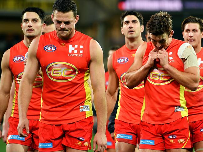 ADELAIDE, AUSTRALIA - AUGUST 26: Steven May and Jarryd Lyons of the Suns walk from the field looking dejected after being defeated by the Power during the round 23 AFL match between the Port Adelaide Power and the Gold Coast Suns at Adelaide Oval on August 26, 2017 in Adelaide, Australia.  (Photo by Daniel Kalisz/Getty Images)