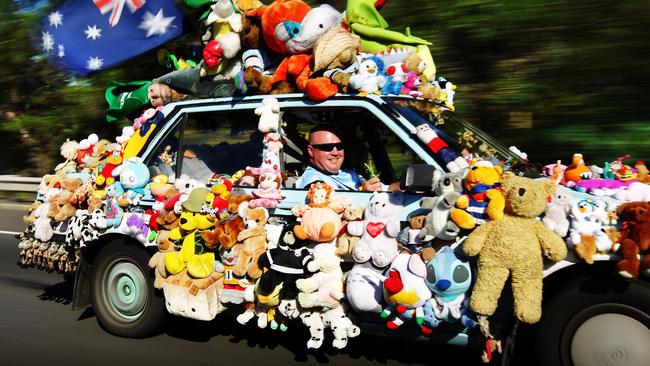 Bruce Mitchelson driving his toy-covered car around Sutherland in 2010.