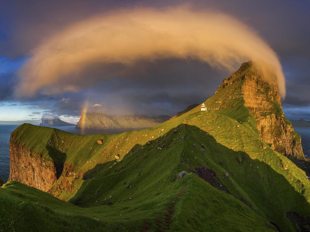 Photo by Wojciech Kruczyński / National Geographic Nature Photographer of the Year contest Kalsoy Kalsoy island and Kallur lighthouse in sunset light, Faroe Islands