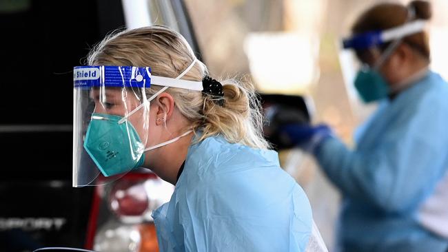 Health workers collect patient information wearing best-practice PPE in July 2021. Picture: Bianca De Marchi