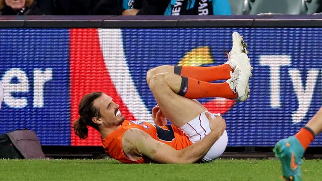 Phil Davis grabs his hamstring on Saturday night. Picture: James Elsby/AFL Photos via Getty Images