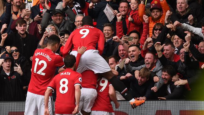 TOPSHOT - Manchester United players celebrate