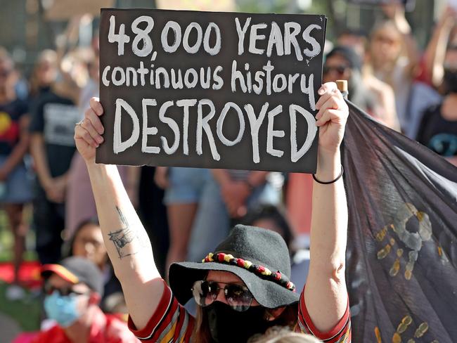 Protesters are seen during a rally outside the Rio Tinto office in Perth, Tuesday, June 9, 2020.. Rio Tinto recently detonated explosives in an area of the Juukan Gorge in the Pilbara, destroying two ancient deep-time rock shelters, much to the distress of the Puutu Kunti Kurrama and Pinikura people. (AAP Image/Richard Wainwright) NO ARCHIVING