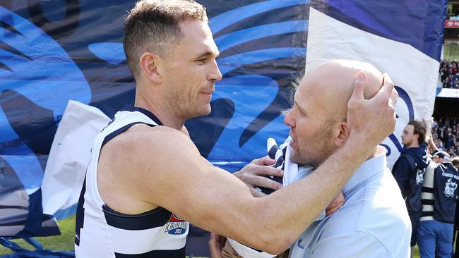 An emotional embrace between Joel Selwood and Gary Ablett after the Geelong captain carried Levi Ablett through the banner. Picture: Michael Klein