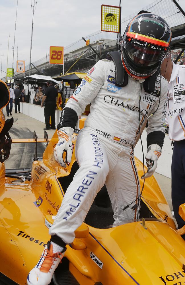 Fernando Alonso, of Spain, climbs out of his car.