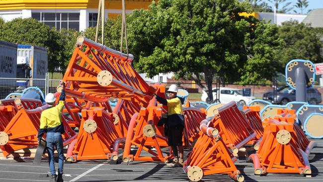 Parts of the new $50 million rollercoaster being unloaded by workmen in the Dreamworld carpark. Picture: Glenn Hampson.