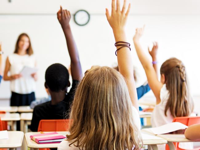 School kids in classroom. Generic (stock) photo of children in a classroom with teacher in background.Picture: iStock