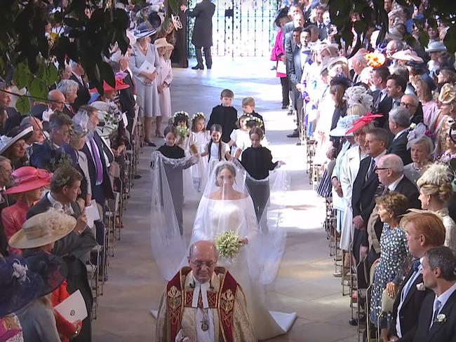 Meghan Markle walks down the aisle with her bridesmaids and pageboys in tow. Picture: BBC via YouTube