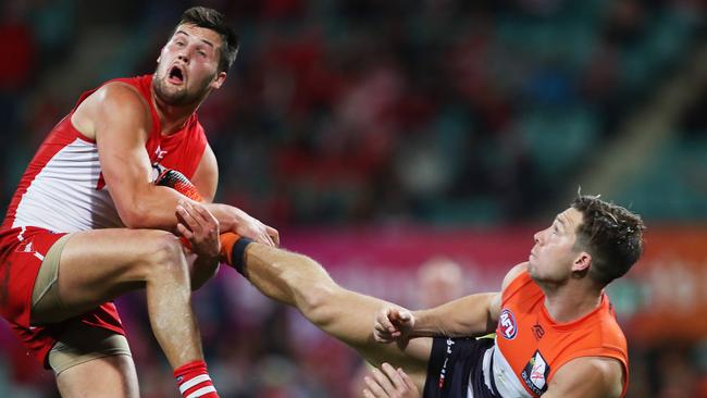 Toby Greene kicks Nic Newman in the final quarter. Picture: Phil Hillyard