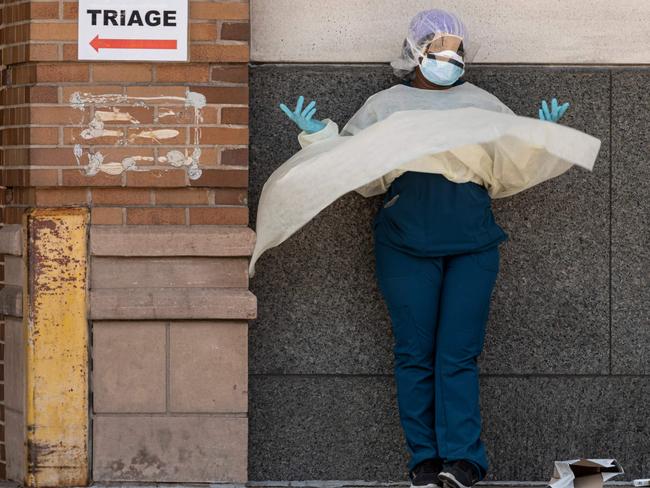 A medical worker makes a phone call during her break outside a special COVID-19 illness area at Maimonides Medical Centre in Brooklyn. Picture: AFP