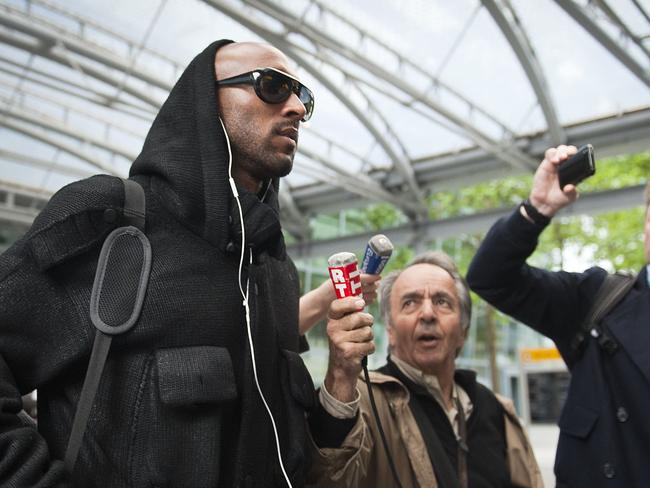 Anelka (L) arrives at Heathrow Airport in London, after being banished from the team.