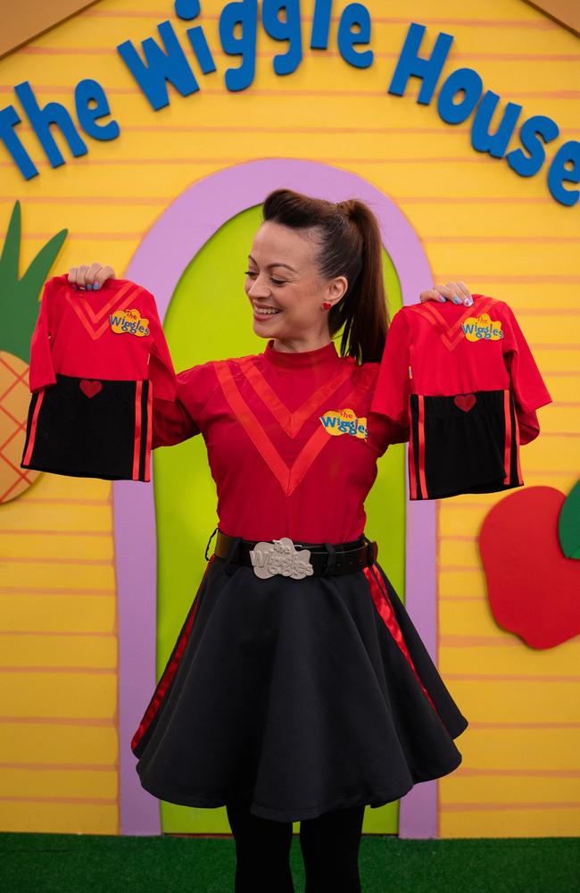 The Wiggles' Caterina Mete held up two mini costumes when she revealed she is pregnant with identical twin girls.