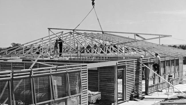 Parents build the first Trinity College log cabin classroom at Evanston. Picture: Supplied