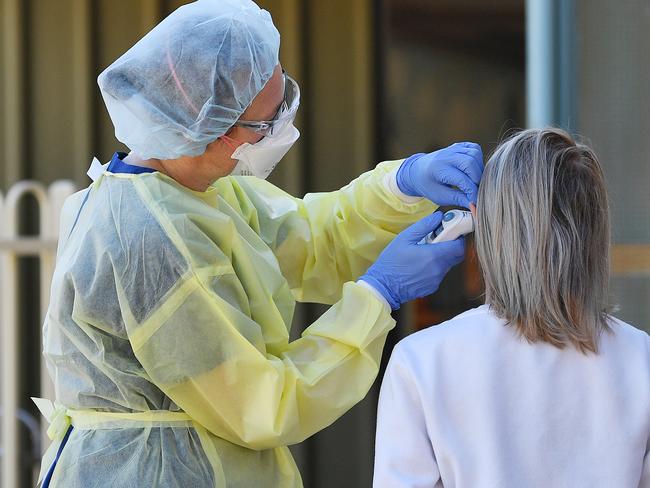 Hospital staff test people outside the Tanunda War Memorial Hospital, a dedicated COVID-19 testing clinic to deal with the expected uptick in cases in the Barossa Valley, northeast of Adelaide, Tuesday, March 31, 2020. The Barossa Valley has had a cluster of 34 cases of coronavirus. (AAP Image/David Mariuz) NO ARCHIVING