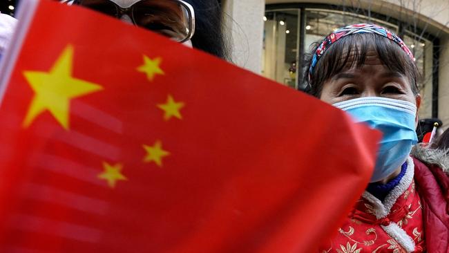 Protestors look on as Taiwan's President Tsai Ing-wen, not pictured, arrives at her hotel in New York City on March 29, 2023, as she begins a ten-day international trip. - Taiwan's President Tsai Ing-wen arrived in New York for a visit that has triggered threats of reprisal by China if she meets with House speaker Kevin McCarthy -- and US warnings for Beijing not to overreact. (Photo by TIMOTHY A. CLARY / AFP)