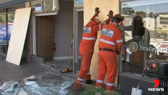 Boarding up the shop after the car had been removed. Picture: 7NEWS