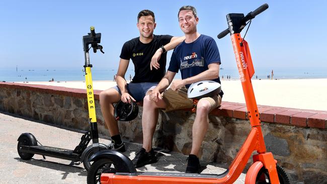 Toby Pym, from RIDE, and Jayden Bryant, from Neuron, at Glenelg Beach when the companies secured the coast licenses in December last year. Picture: Tricia Watkinson