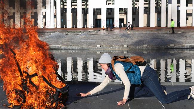 Extinction Rebellion protesters earlier this month attacked the front of Parliament House, lighting a baby's pram and glueing their hands to the forecourt. Picture: NCA NewsWire / Gary Ramage