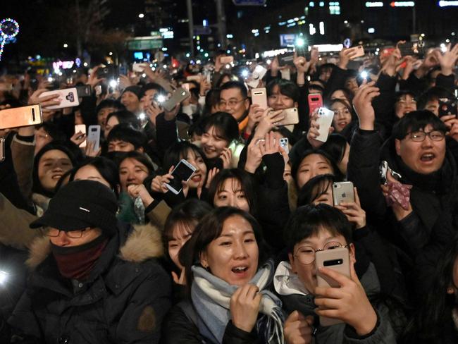 People celebrate after midnight during a countdown event to mark the New Year at the Bosingak pavilion in central Seoul. Picture: AFP