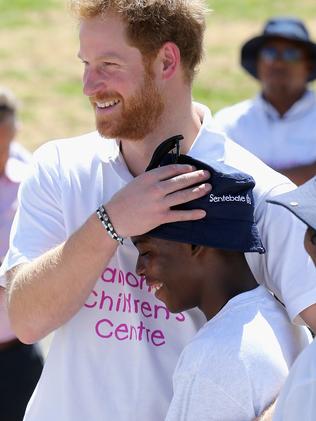 MASERU, LESOTHO - NOVEMBER 26: In this handout provided by Sentebale, Prince Harry hugs 'Mutso' a young boy he made friends with on his first visit to Lesotho at the Official Opening of the new Mamohato Children's Centre on October 17, 2015 in Maseru, Lesotho. In a photography project supported by Getty Images the vulnerable children at the Mamohato Camp have been using Instant photography as an educational tool to build interpersonnel skills and creativity. The Sentebale Mamohato Children's Centre at Thaba Bosiu just outside Maseu is Sentebale's first purpose built camp for the disadvantaged and HIV positive childen of Lesotho. Getty Images Sentebale is a charity started by Prince Harry and Prince Seeiso of Lesotho ten years ago to help the vulnerable children of Lesotho. (Photo by Chris Jackson/Getty Images for Sentebale)