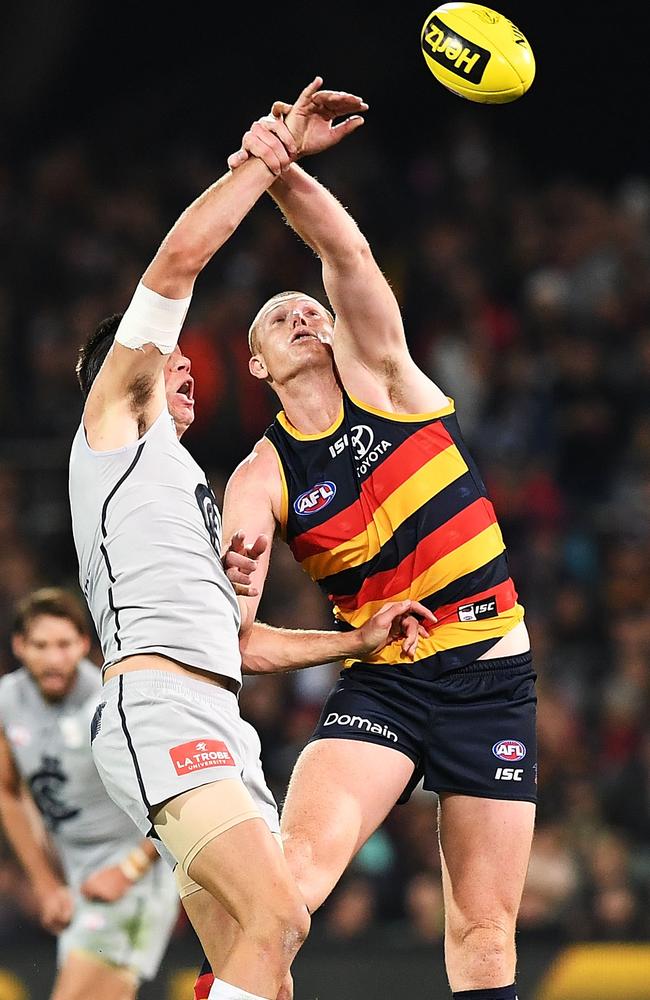 Matthew Kreuzer of the Blues and Sam Jacobs of the Crows compete for the ball.