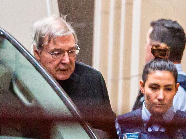 Australian Cardinal George Pell (L) is escorted into the Supreme Court of Victoria in Melbourne on June 6, 2019. - Pell asked appeals court judges to quash his landmark conviction for child sex abuse, branding the charges against him "bizarre" and "impossible". (Photo by ASANKA BRENDON RATNAYAKE / AFP)