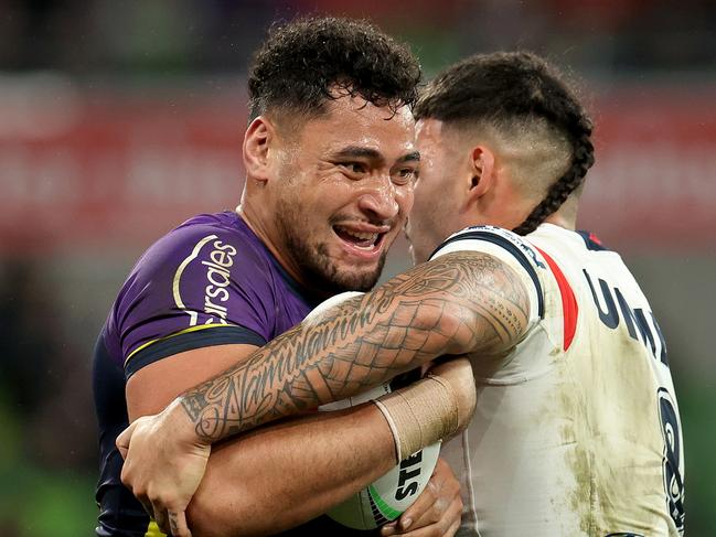 MELBOURNE, AUSTRALIA - JULY 20: Eliesa Katoa of the Storm is tackled by Terrell May of the Roosters during the round 20 NRL match between Melbourne Storm and Sydney Roosters at AAMI Park, on July 20, 2024, in Melbourne, Australia. (Photo by Kelly Defina/Getty Images)