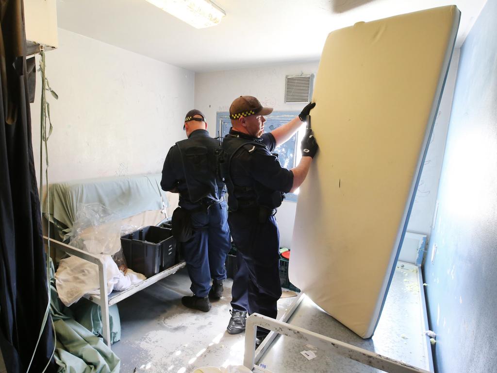 Corrective Services officers raid cells at Silverwater Jail looking for contraband. The officers now wear body cams that record the raids. Picture: Richard Dobson