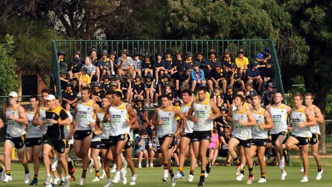 Schoolchildren watch on as Richmond conducts a training session in Mildura during a 2012 community camp.